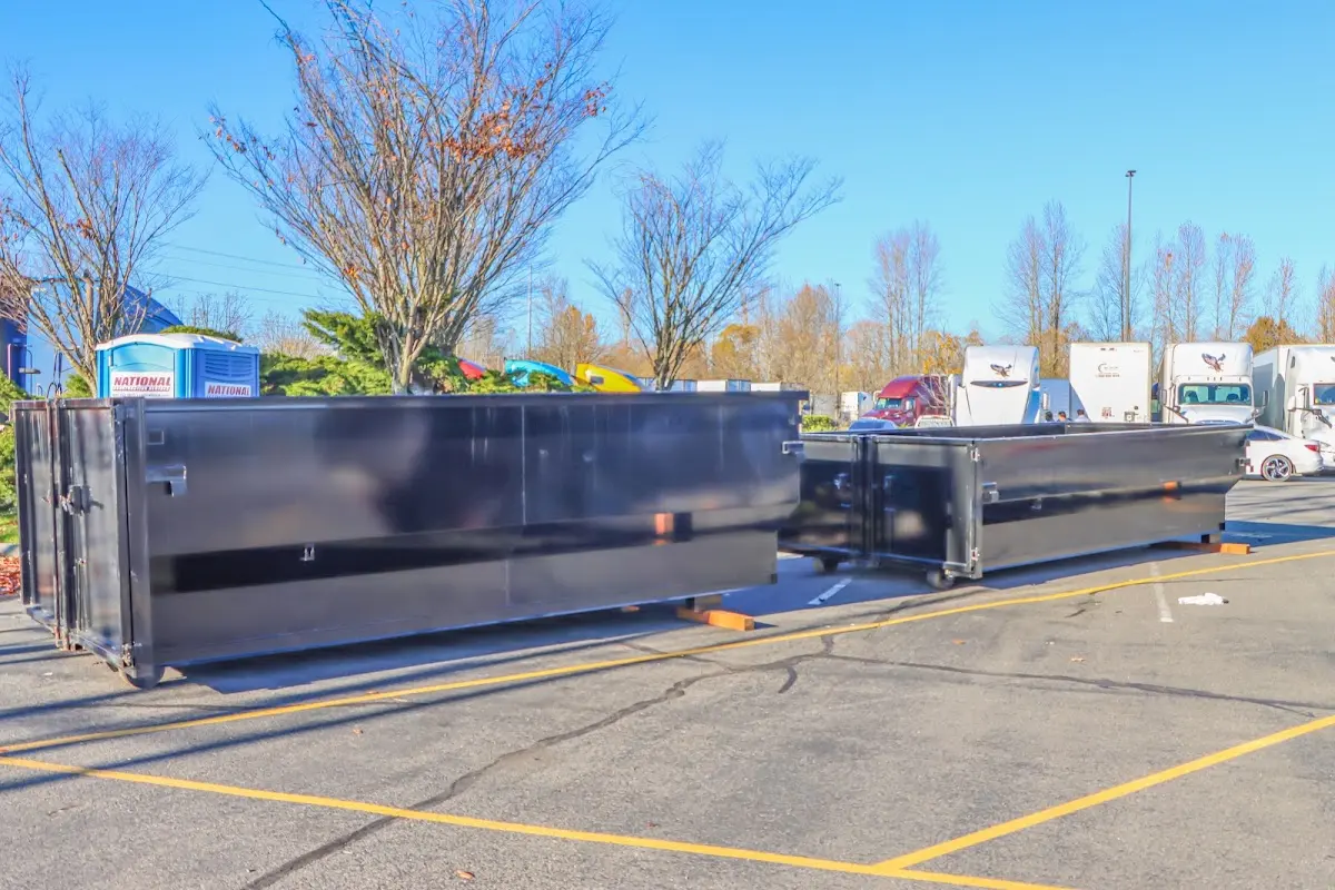 Professional dumpster rental service with roll-off container on residential driveway in Paradise Valley